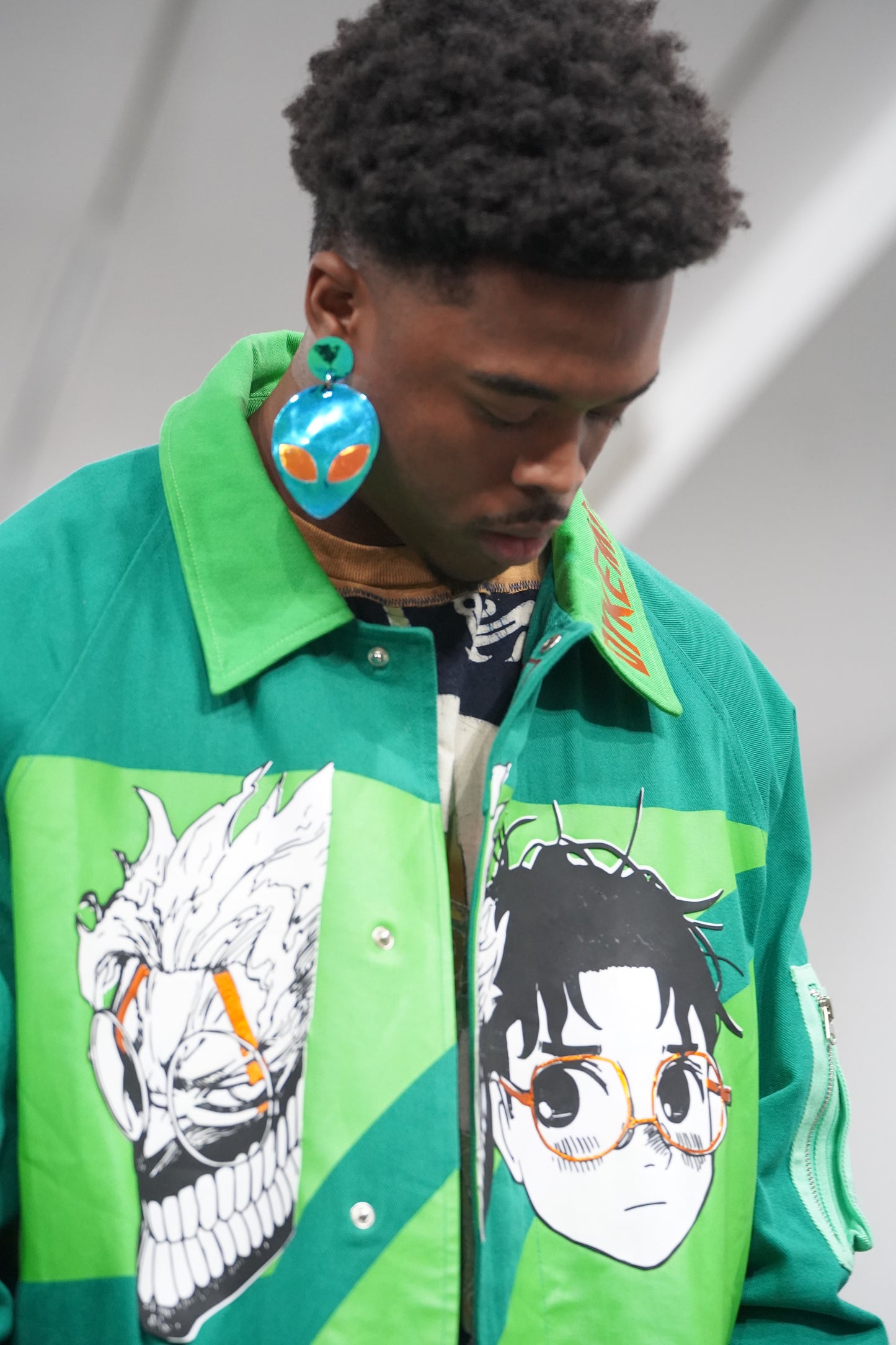 the faces of yokai, aliens, and a human trench coat —NYFW